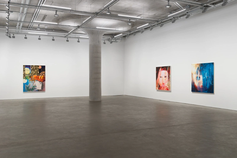 Three paintings displayed across two white gallery walls.