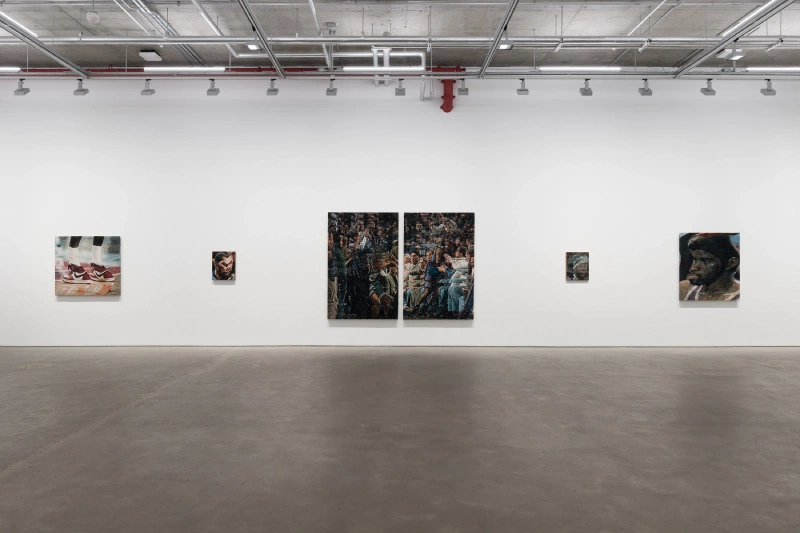 Six mixed-media works displayed across a wide white gallery wall.